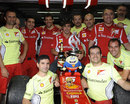 Fernando Alonso celebrates with his team and car after winning the German Grand Prix