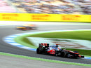 Jenson Button leads Sebastian Vettel on track