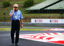 FIA race director Charlie Whiting walks the track