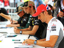 Jenson Button signs autographs on Thursday