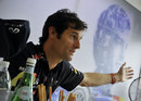Mark Webber gestures as he answers questions from the media