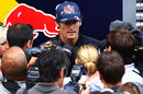 Mark Webber faces the media outside the Red Bull motorhome