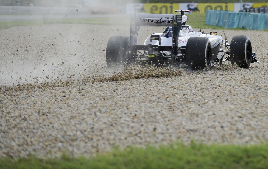 Pastor Maldonado runs through the gravel during FP1