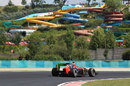 Timo Glock passes the water park with flo-viz paint on his rear wing
