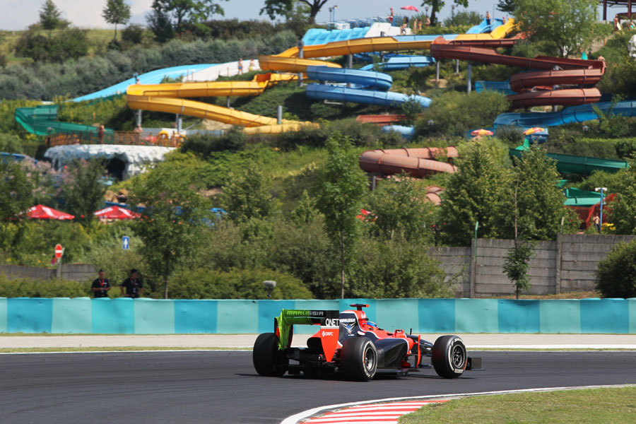 Timo Glock passes the water park with flo-viz paint on his rear wing