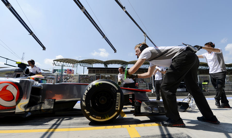 Lewis Hamilton makes a pit stop during a practice session