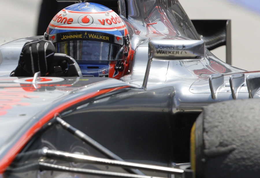 Jenson Button aims for his pit marks as he returns to the pits