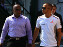 Lewis Hamilton arrives in the paddock with his father Anthony