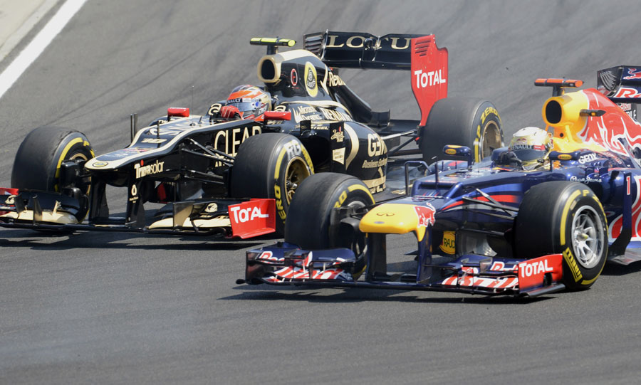 Romain Grosjean holds off Sebastian Vettel in the first corner
