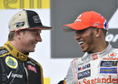 Kimi Raikkonen and Lewis Hamilton share a joke on the podium