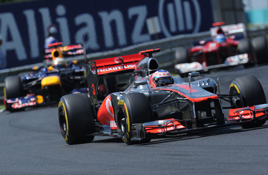 Jenson Button leads Sebastian Vettel and Fernando Alonso on track