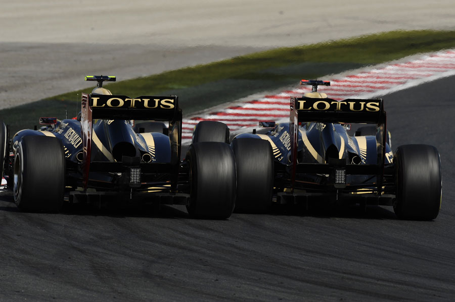 Kimi Raikkonen and Romain Grosjean go wheel-to-wheel for second place