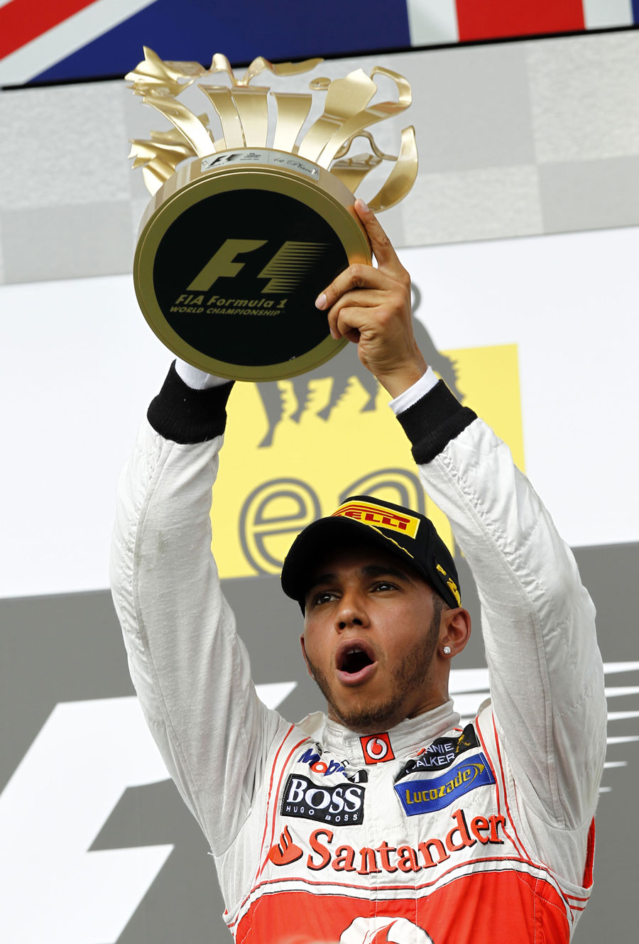 Lewis Hamilton celebrates with his trophy on the podium