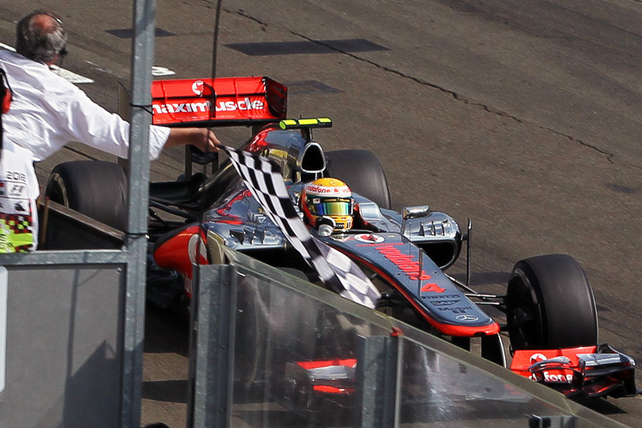 Lewis Hamilton celebrates as he crosses the line