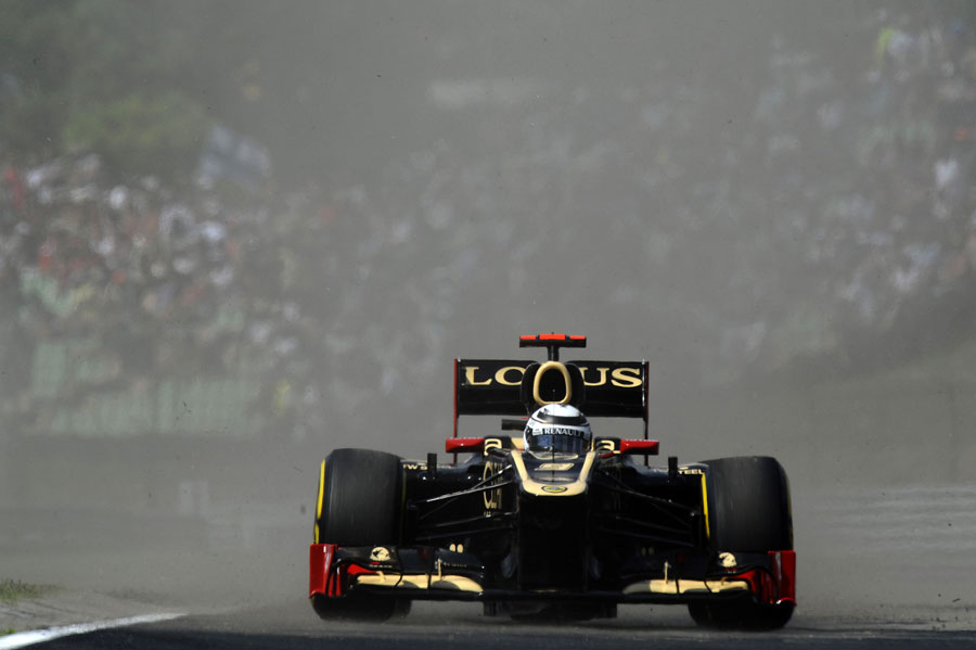 Kimi Raikkonen emerges through a cloud of dust