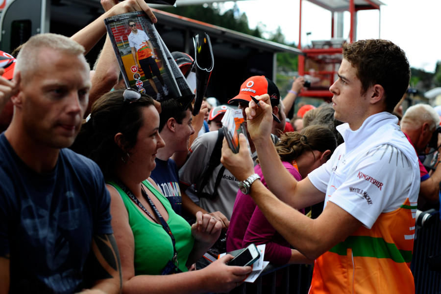 Paul di Resta signs autographs for the fans in the pit lane