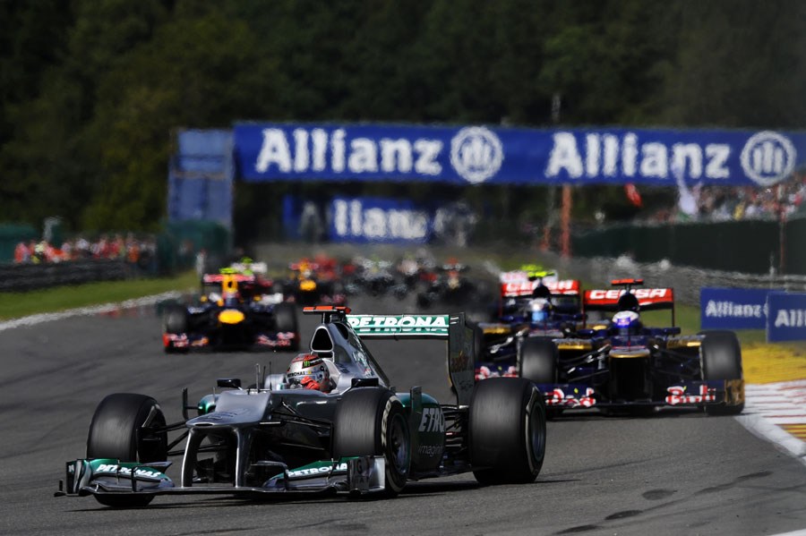 Michael Schumacher leads a pack of cars into Les Combes