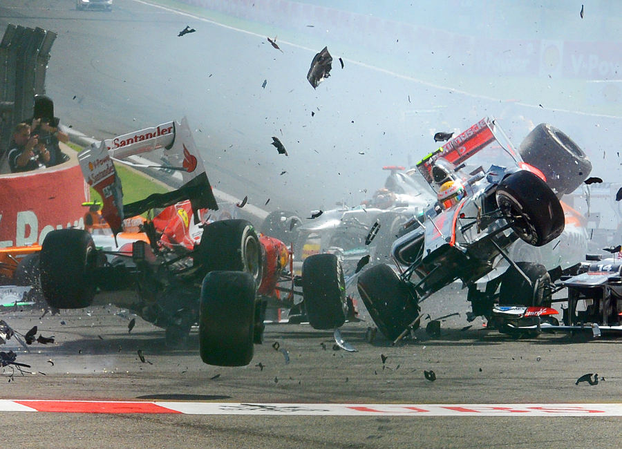 Fernando Alonso and Lewis Hamilton get airborne after being taken out by Romain Grosjean