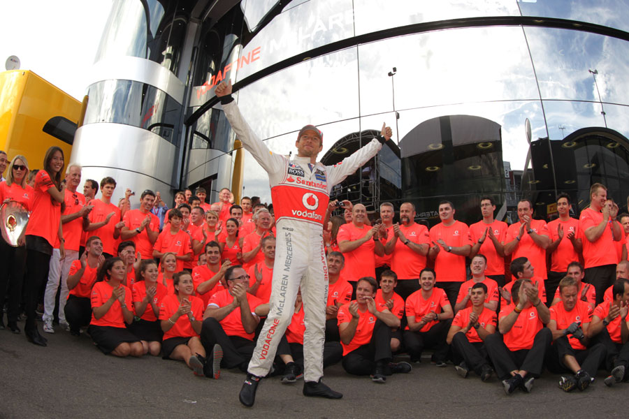 Jenson Button celebrates victory with his team