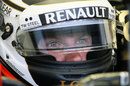Kimi Raikkonen stares while waiting in the Lotus garage