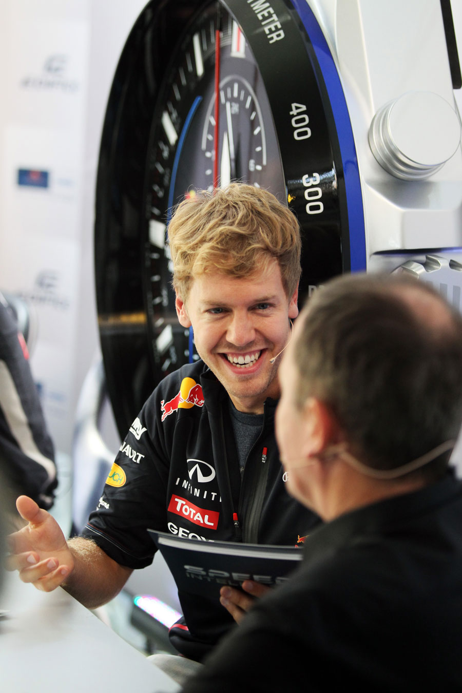 Sebastian Vettel laughs during a sponsors' quiz in the paddock on Thursday