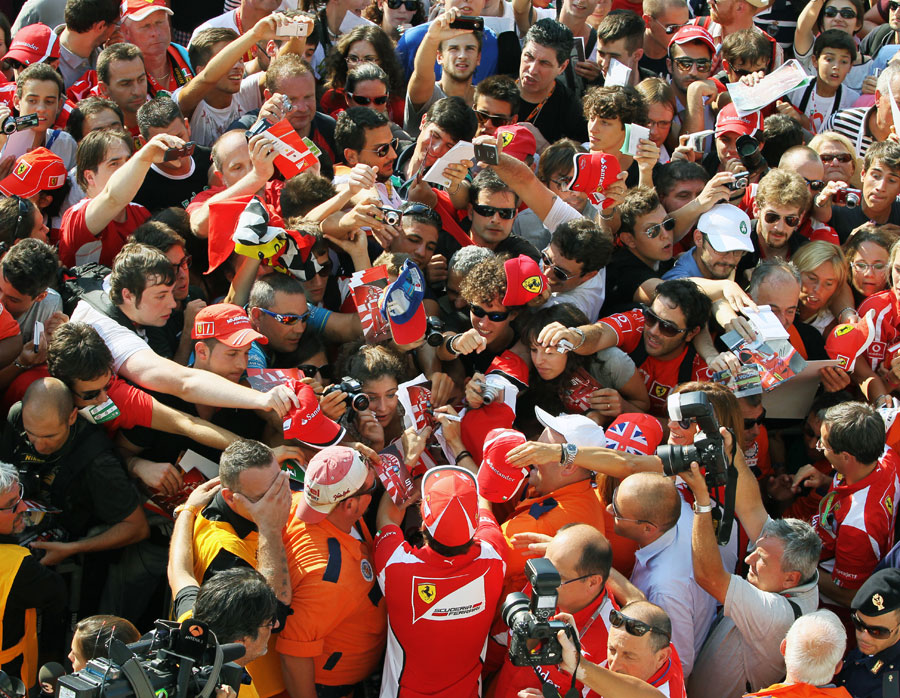 Fernando Alonso signs autographs for the Tifosi at Monza