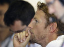 Jenson Button studies data in the McLaren garage