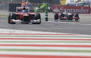 Fernando Alonso pits as Jenson Button continues for another lap