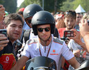 Jenson Button arrives in the paddock on Sunday