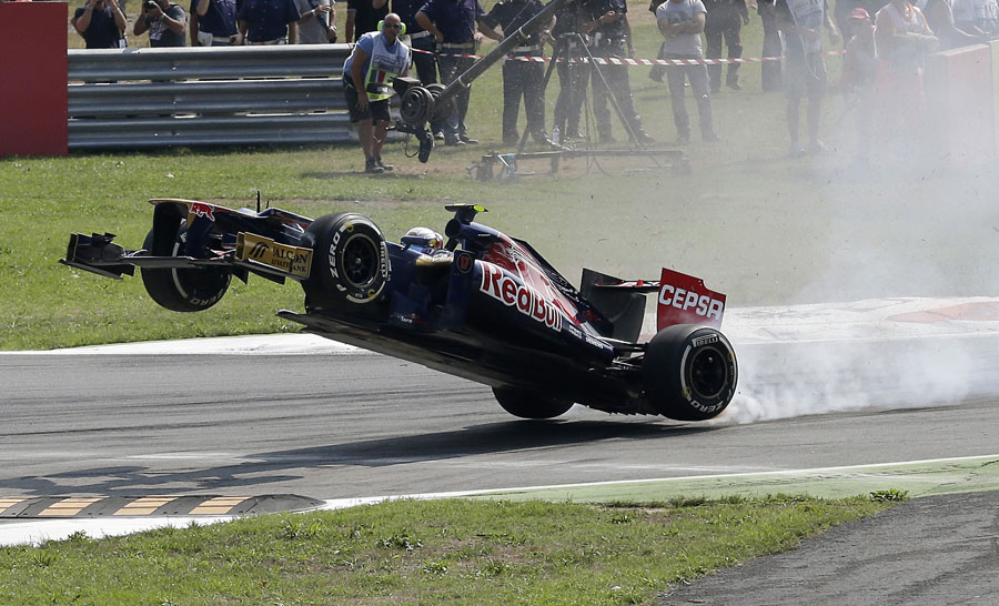Jean-Eric Vergne launches his car over the kerbs at turn one