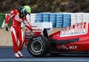 Felipe Massa checks his tyres after his Ferrari stops out on track