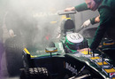 Heikki Kovalainen's Lotus is wheeled back into the garage