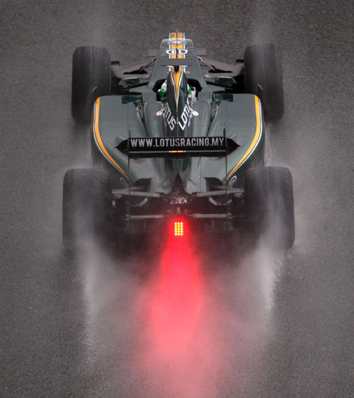 Heikki Kovalainen's Lotus trundles down the pit lane