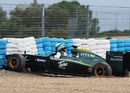 Heikki Kovalainen beaches his Lotus 