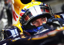 Mark Webber sits in the Red Bull garage