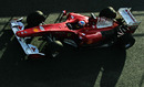 Fernando Alonso drives down the pit lane in his Ferrari