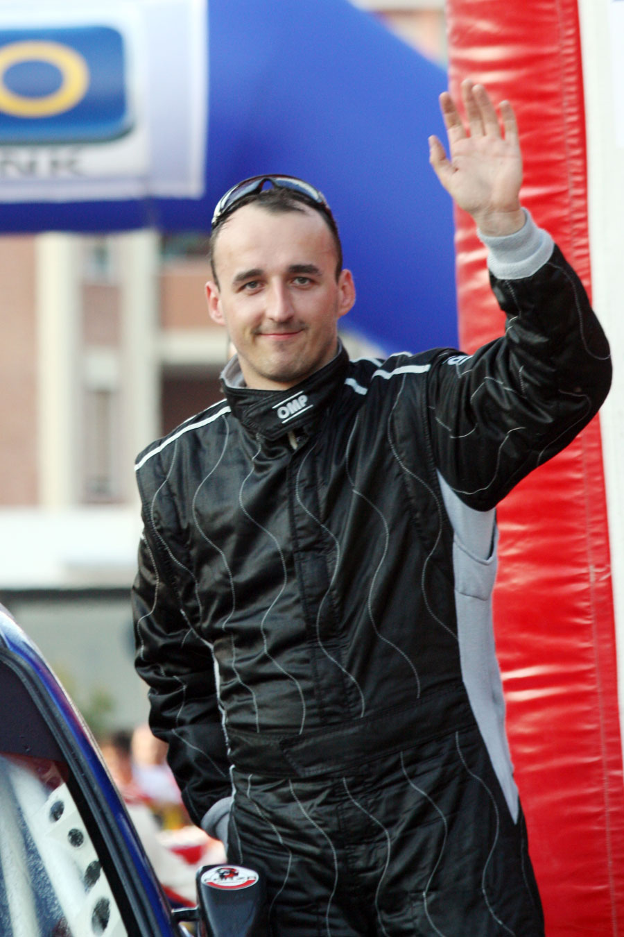 Robert Kubica waves to the crowd on the podium