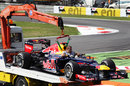 Sebastian Vettel's Red Bull is returned to the pit lane