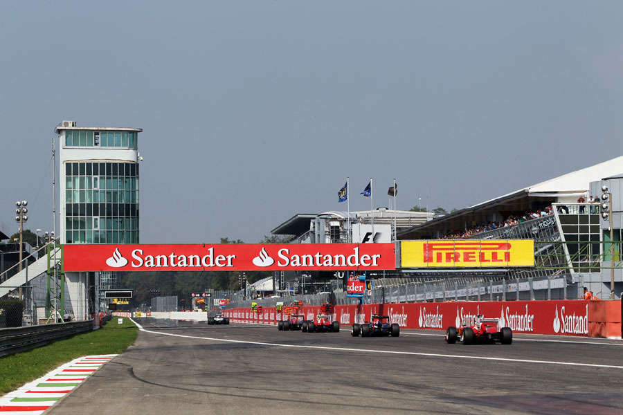 Fernando Alonso chases Sebastian Vettel and Felipe Massa down the start/finish straight