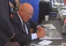 Fifty years after his near-fatal crash at Goodwood, Sir Stirling Moss signs copies of his book for fans