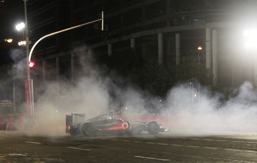 Lewis Hamilton displays a McLaren at an event for sponsor Vodafone in Mumbai