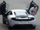 Lewis Hamilton is all smiles after performing burnouts in a McLaren MP4-12C at a promotional event
