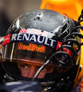Sebastian Vettel sits in the Red Bull's cockpit with a new LED-lit helmet design