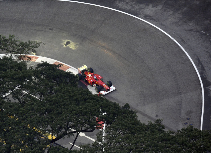 Fernando Alonso on track in damp conditions at the start of the session
