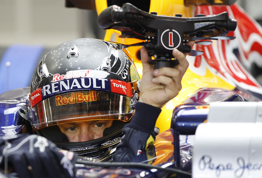 Sebastian Vettel prepares to get out of his car