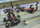 Sebastian Vettel and Mark Webber return to the Red Bull garages after practice