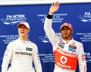 Lewis Hamilton celebrates his pole position with Michael Schumacher in parc ferme