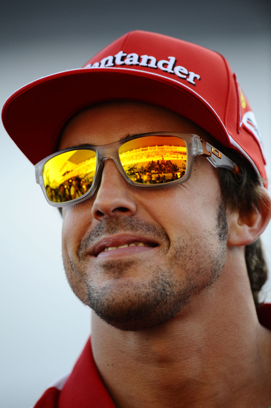 Fernando Alonso smiles at fans in the pit lane