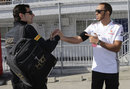Lewis Hamilton greets Pedro de la Rosa in the paddock on Friday