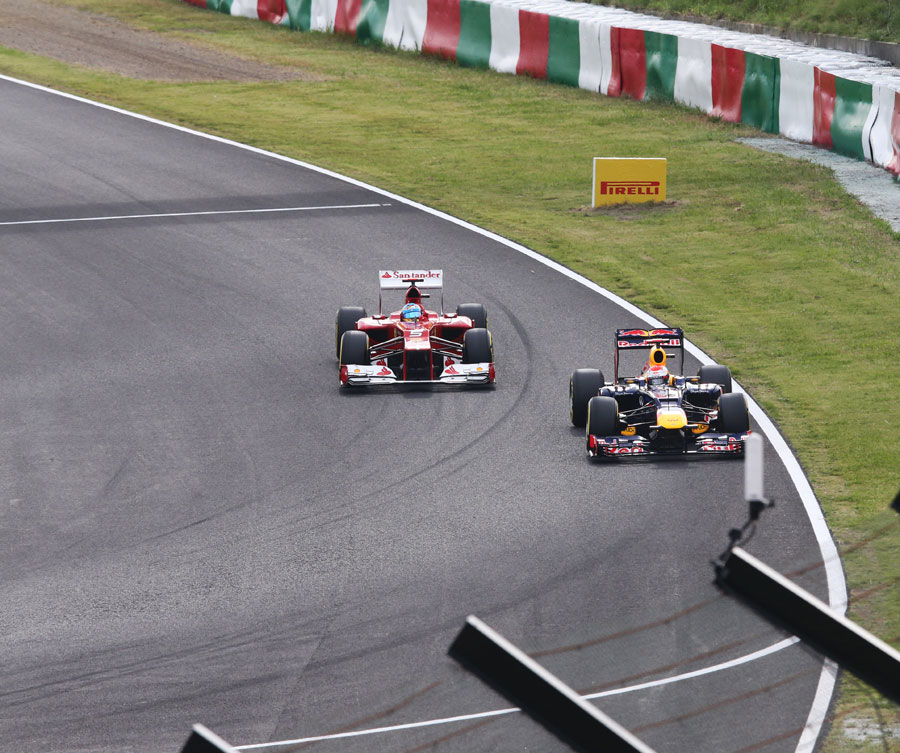 Fernando Alonso comes up behind Sebastian Vettel during qualifying 